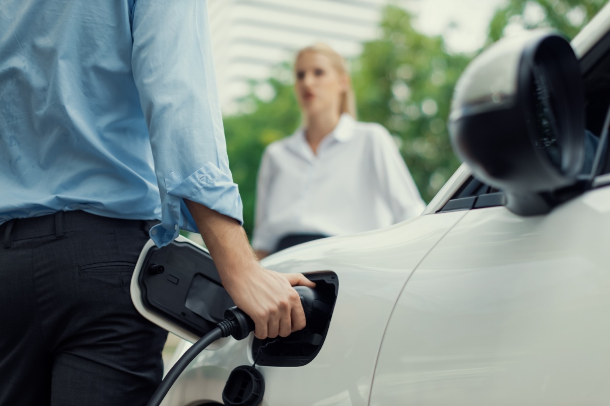 closeup-focus-hand-insert-progressive-ev-charger-with-blurred-background-1